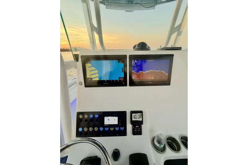 Slide: The Image of 2019 Cape Horn 27 boat dashboard with navigation screens at sunset. - 29