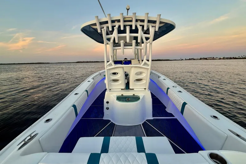 Slide: The Image of 2019 Cape Horn 27 boat interior with blue LED lighting at sunset on the water. - 30