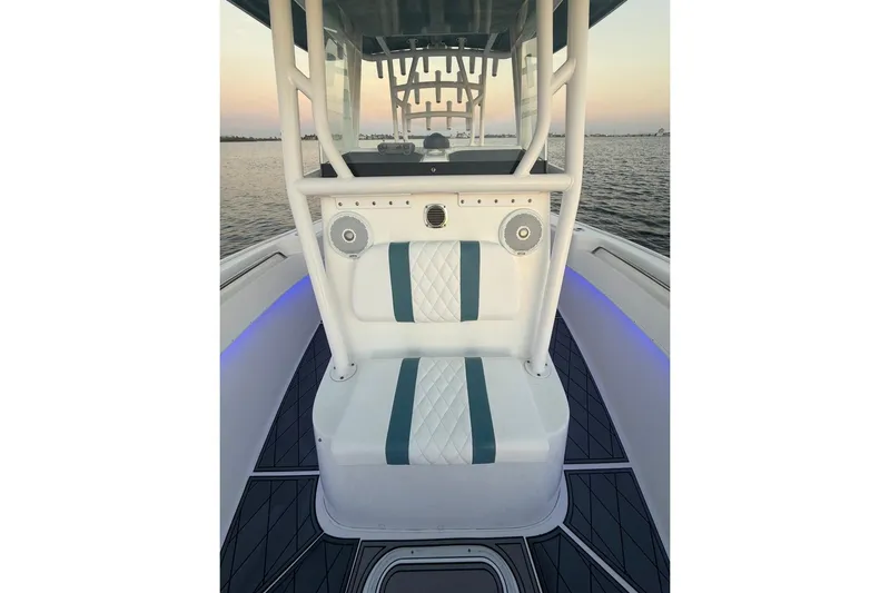 Slide: The Image of 2019 Cape Horn 27 boat interior with cushioned seating and ocean view. - 33