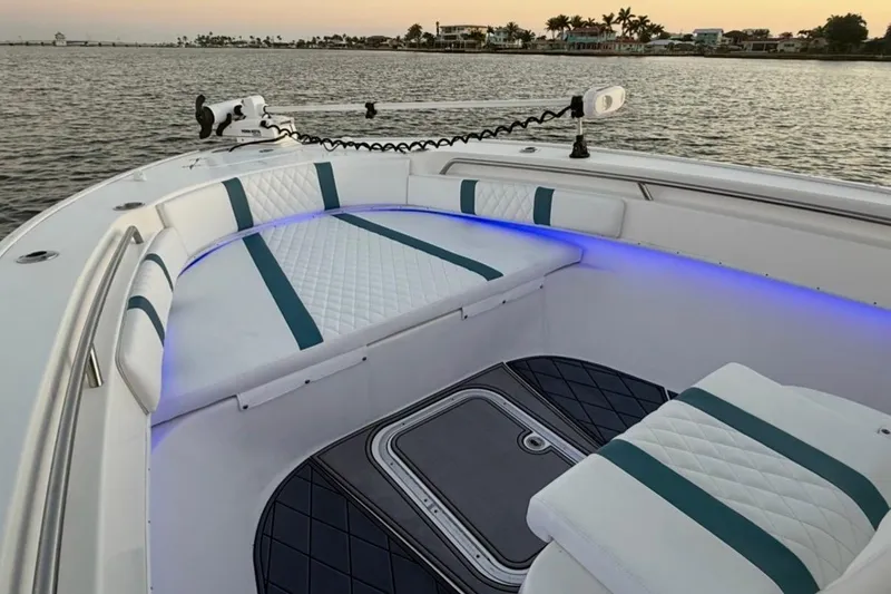 Slide: The Image of 2019 Cape Horn 27 boat interior with cushioned seating and ambient lighting. - 37