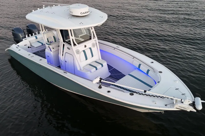 Slide: The Image of 2019 Cape Horn 27 boat with dual engines and illuminated interior on calm water. - 9