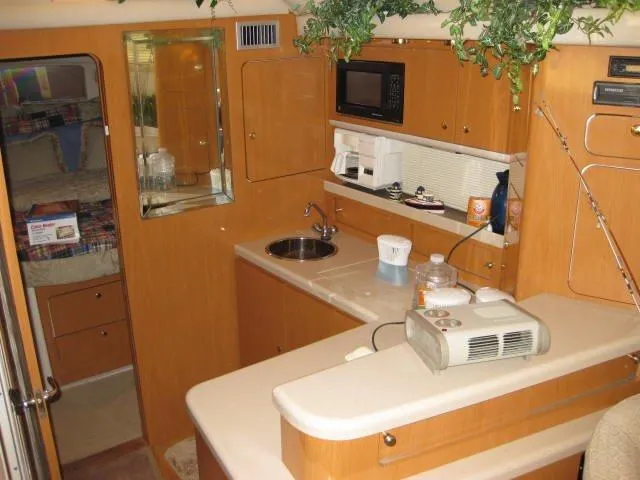 Slide: The Image of 2001 Regal Commodore 3880 yacht interior with stairs and sliding doors in a marina. - 10