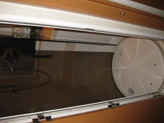 Slide: The Image of 2001 Regal Commodore 3880 boat interior with storage compartments and red kayak on deck. - 15