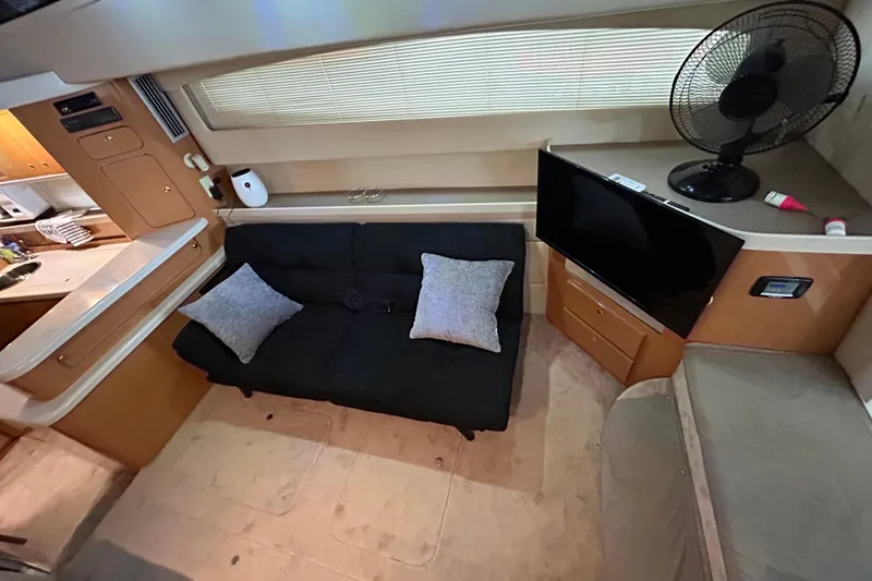 Slide: The Image of Interior of 2001 Regal Commodore 3880 yacht with sofa, TV, and fan. - 18