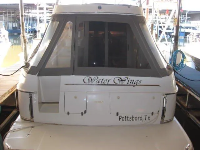 Slide: The Image of 2001 Regal Commodore 3880 yacht docked, rear view with "It's Always Something" text. - 2