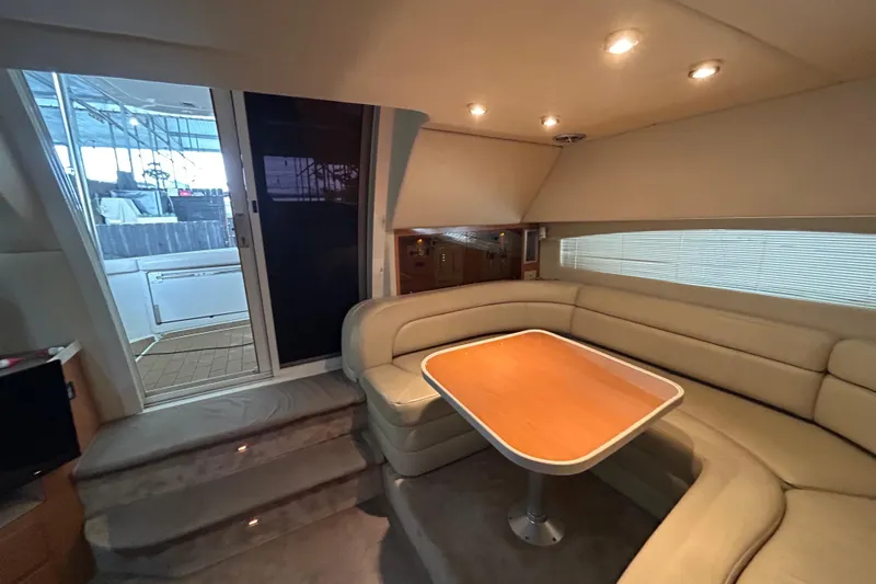 Slide: The Image of Interior of 2001 Regal Commodore 3880 yacht with beige seating and wooden table. - 20