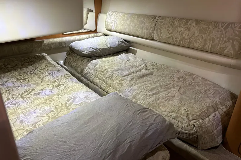 Slide: The Image of Interior cabin of 2001 Regal Commodore 3880 with twin beds and floral bedding. - 22