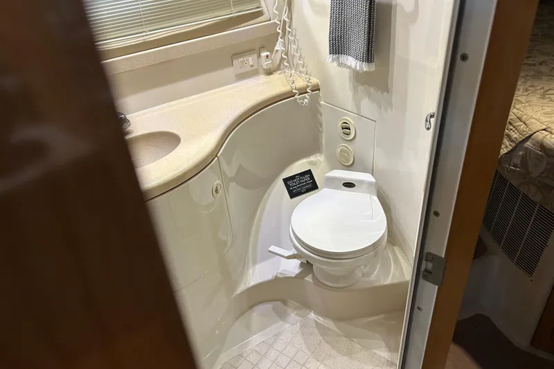Slide: The Image of Bathroom in 2001 Regal Commodore 3880 yacht with toilet, sink, and towel. - 25