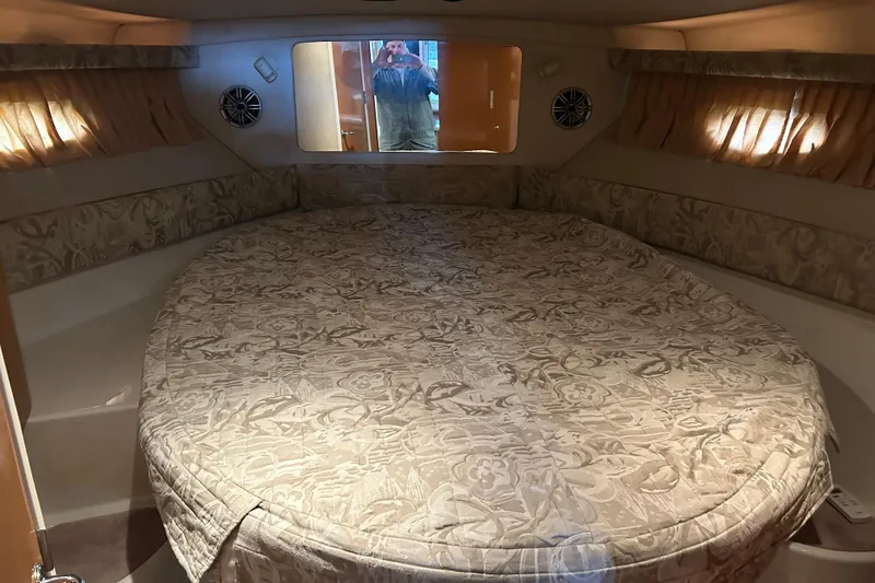 Slide: The Image of Cozy cabin interior of 2001 Regal Commodore 3880 with floral-patterned bedding. - 26