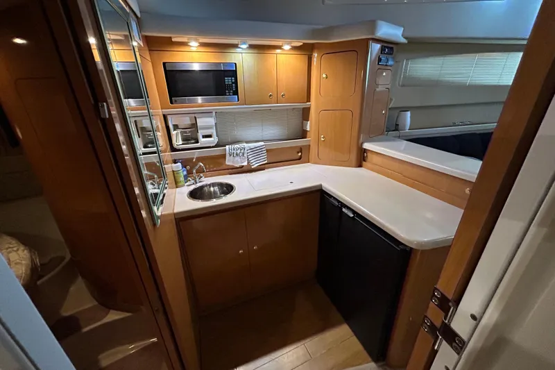 Slide: The Image of 2001 Regal Commodore 3880 yacht kitchen with modern appliances and wooden cabinetry. - 27