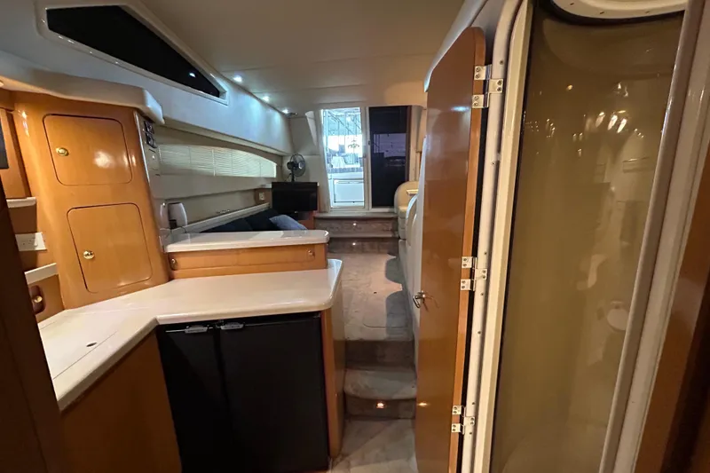 Slide: The Image of Interior of 2001 Regal Commodore 3880 yacht with modern kitchen and seating area. - 28