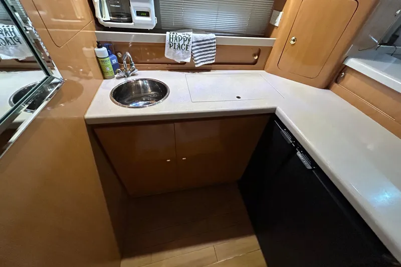 Slide: The Image of Compact kitchen area in 2001 Regal Commodore 3880 yacht with sink and appliances. - 29