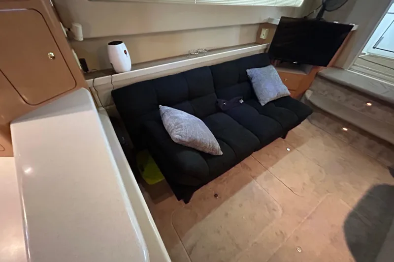 Slide: The Image of Interior of 2001 Regal Commodore 3880 yacht with black sofa and TV. - 30