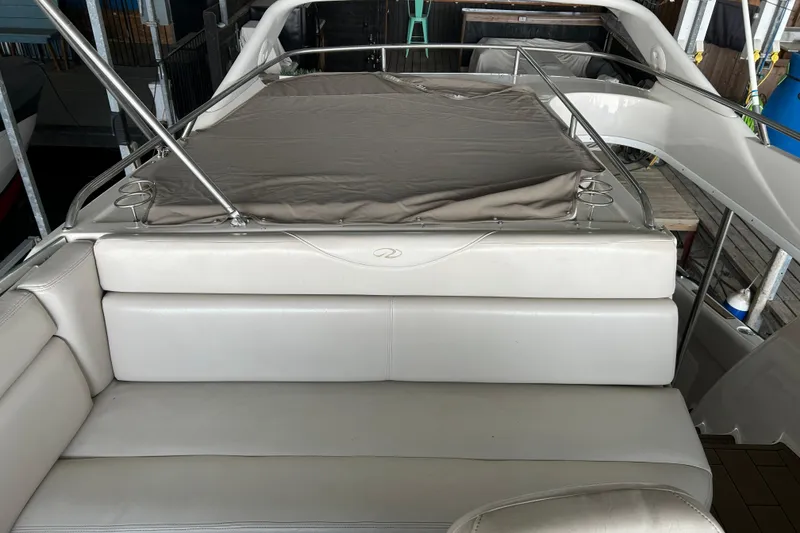 Slide: The Image of 2001 Regal Commodore 3880 boat interior with cushioned seating and metal railings. - 33