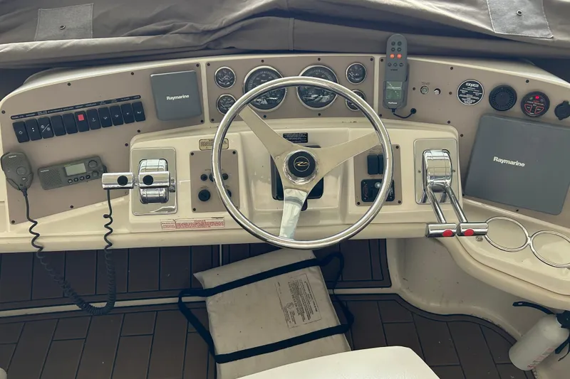 Slide: The Image of 2001 Regal Commodore 3880 boat dashboard with steering wheel and navigation controls. - 34