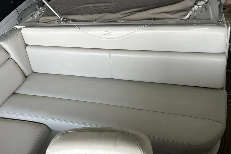 Slide: The Image of White leather seating on a 2001 Regal Commodore 3880 boat, featuring cup holders. - 37