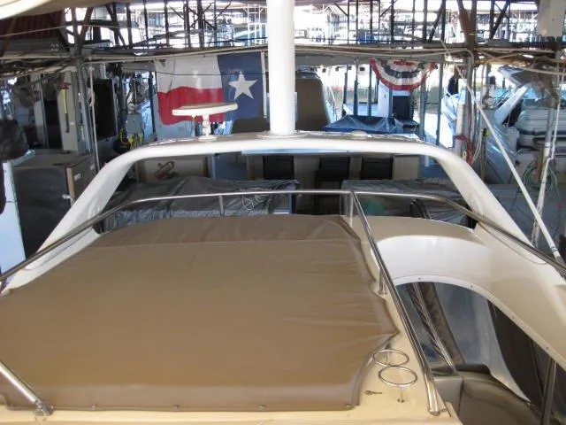 Slide: The Image of 2001 Regal Commodore 3880 yacht docked in covered marina, side view. - 7