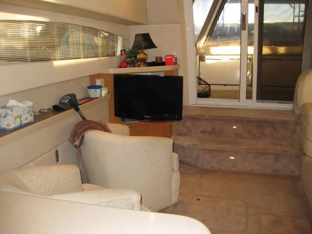 Slide: The Image of 2001 Regal Commodore 3880 boat docked, featuring a wooden deck and sleek design. - 8