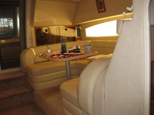 Slide: The Image of 2001 Regal Commodore 3880 yacht interior with seating and stairs, showcasing elegant design. - 9