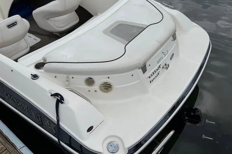 Slide: The Image of 2010 Larson LX 1750 boat with white seating and sleek design on water. - 6