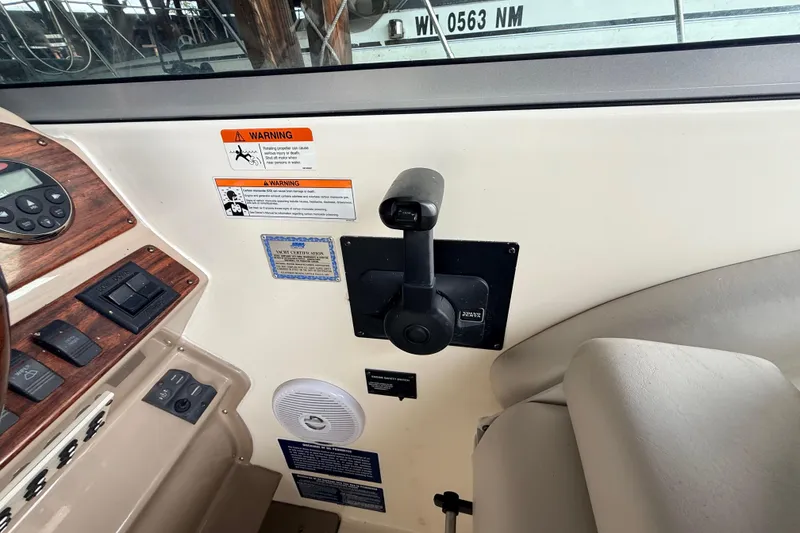 Slide: The Image of 2007 Glastron GS 279 boat cockpit controls with warning labels and throttle lever. - 10