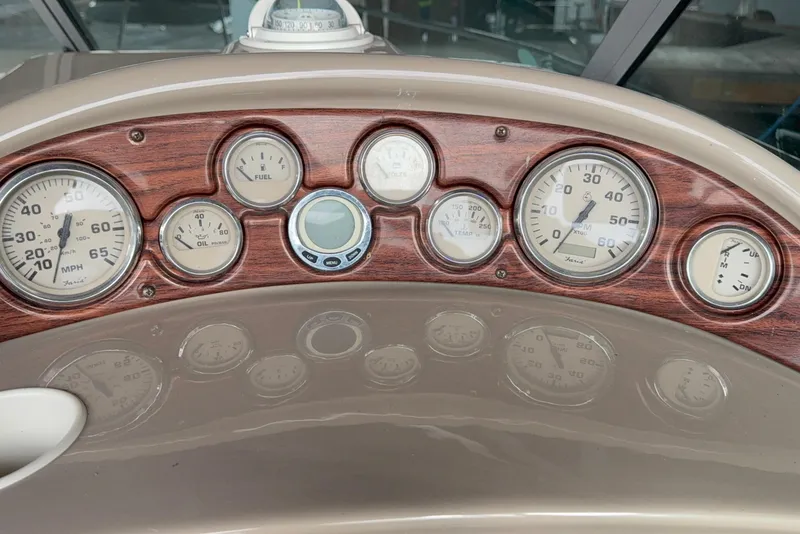Slide: The Image of 2007 Glastron GS 279 dashboard with wood paneling and various gauges. - 11