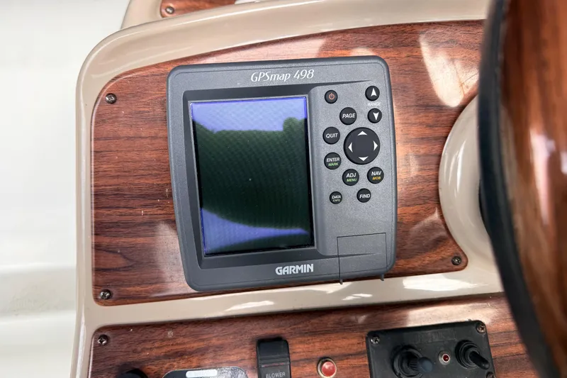 Slide: The Image of Garmin GPSmap 498 on 2007 Glastron GS 279 boat dashboard with wood paneling. - 12