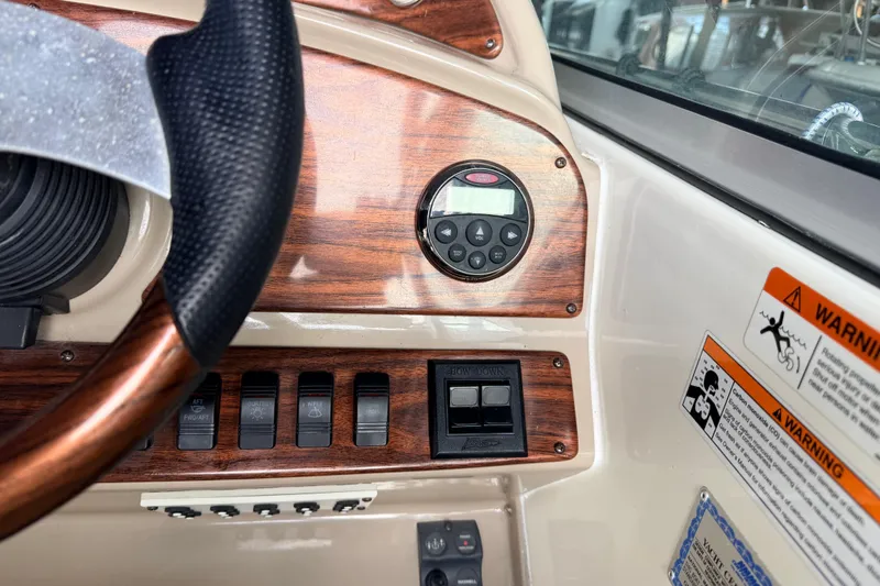 Slide: The Image of 2007 Glastron GS 279 dashboard with wood accents and control panel. - 13