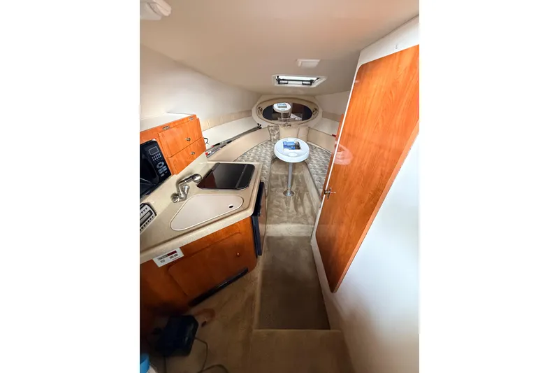 Slide: The Image of 2007 Glastron GS 279 cabin interior with kitchenette and seating area. - 15