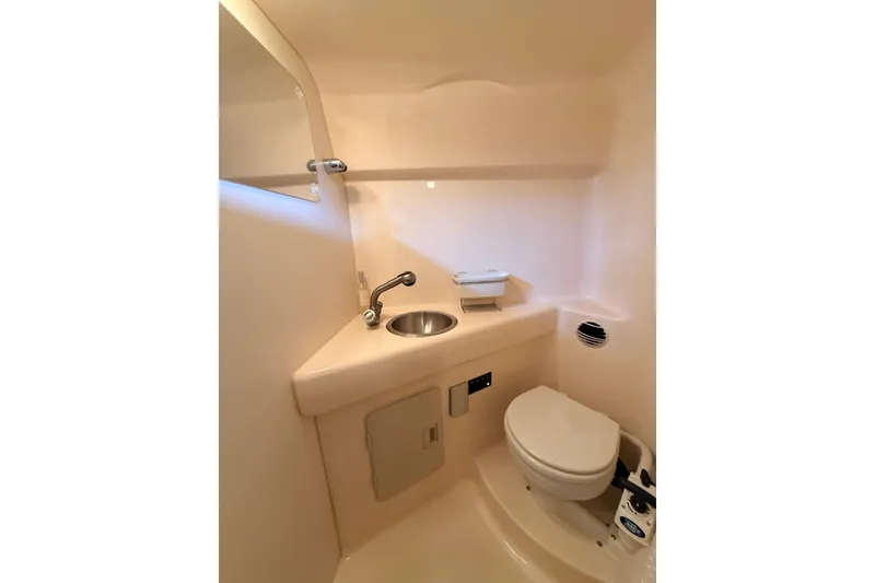 Slide: The Image of 2007 Glastron GS 279 boat bathroom with sink, toilet, and mirror. - 16