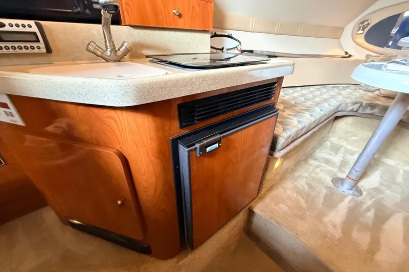 Slide: The Image of 2007 Glastron GS 279 boat interior with kitchenette and seating area. - 18