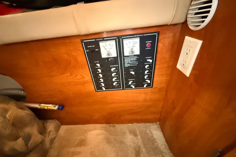 Slide: The Image of Control panel in 2007 Glastron GS 279 boat interior, featuring switches and meters. - 25