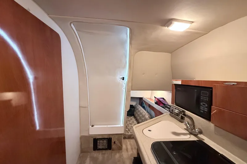Slide: The Image of Interior of 2007 Glastron GS 279 boat with kitchenette and seating area. - 28