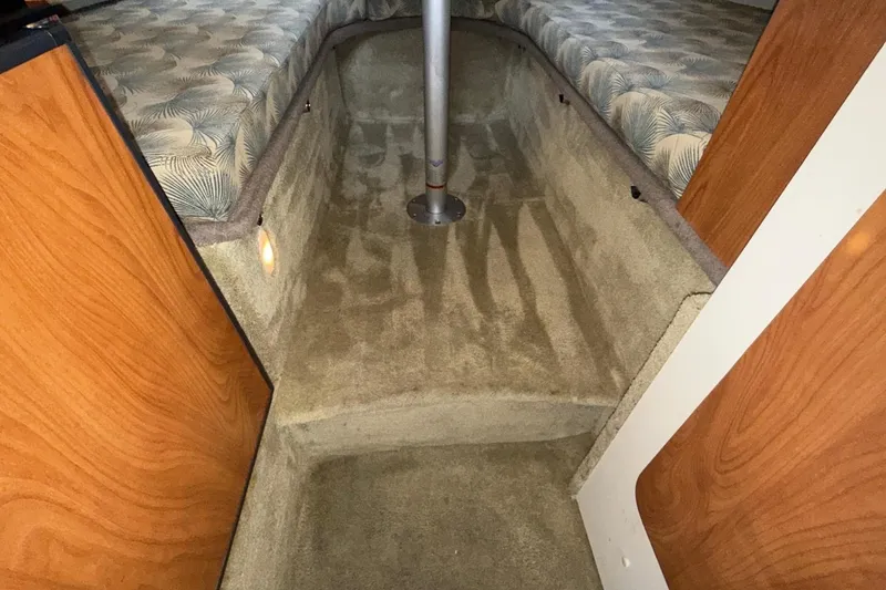 Slide: The Image of 2007 Glastron GS 279 cabin interior with carpeted floor and patterned upholstery. - 37