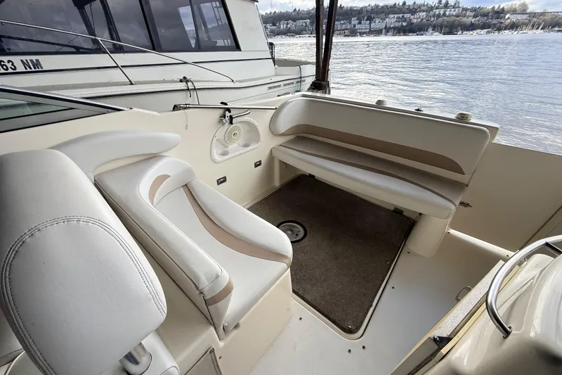 Slide: The Image of 2007 Glastron GS 279 boat interior with beige seating and lake view. - 6