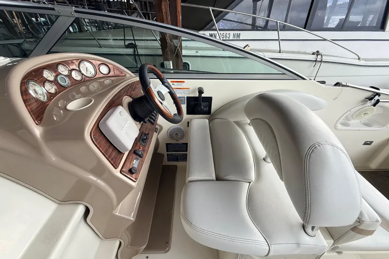 Slide: The Image of 2007 Glastron GS 279 boat cockpit with steering wheel and control panel. - 7