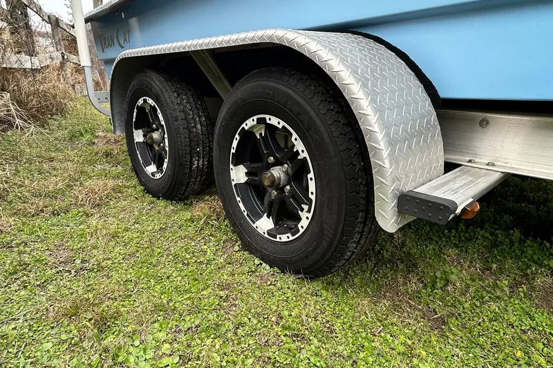 Slide: The Image of Trailer wheels of a 2022 Transcat 200 SVT on grassy terrain. - 10