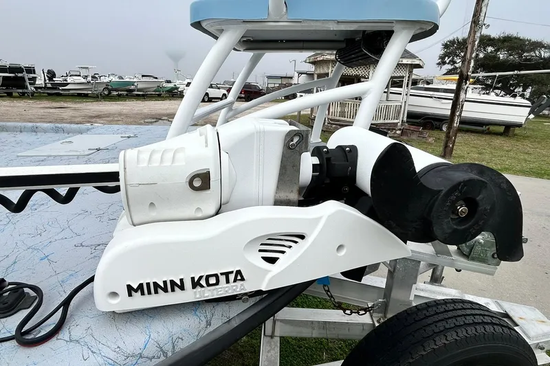 Slide: The Image of Minn Kota Ulterra motor on 2022 Transcat 200 SVT boat, docked with other boats. - 12