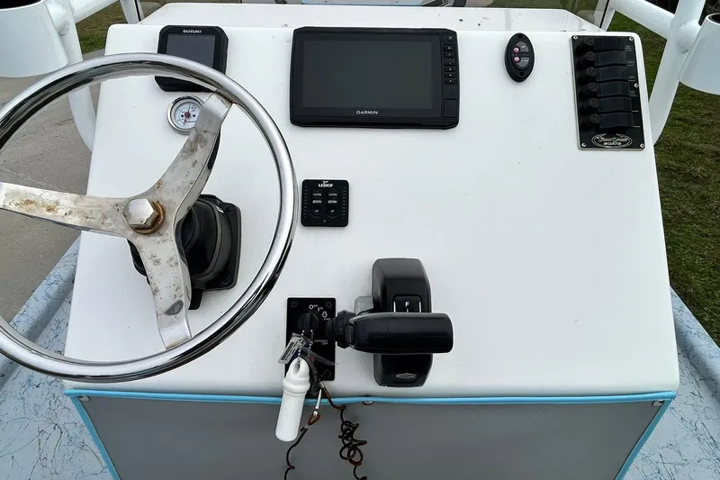 Slide: The Image of 2022 Transcat 200 SVT boat console with steering wheel, controls, and Garmin display. - 19
