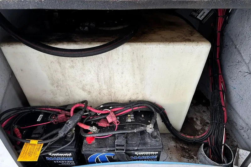 Slide: The Image of Battery compartment of a 2022 Transcat 200 SVT with wiring and marine batteries. - 25