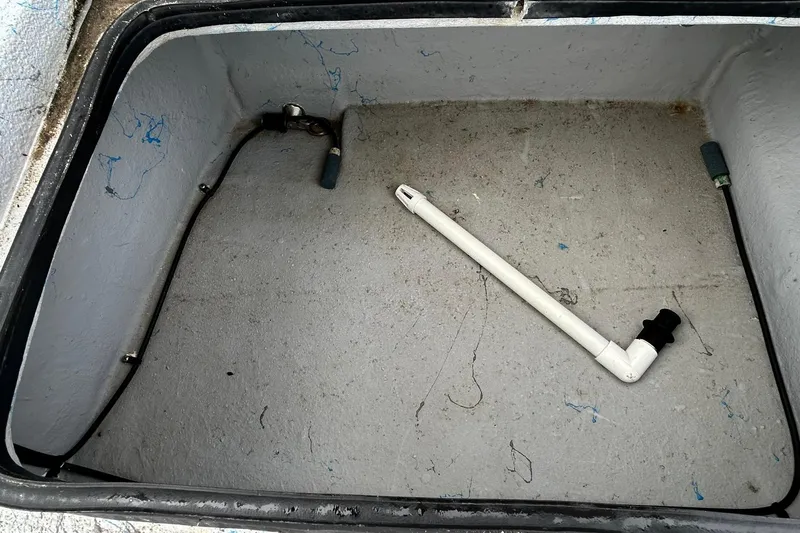 Slide: The Image of Empty storage compartment of a 2022 Transcat 200 SVT boat with a white pipe inside. - 27
