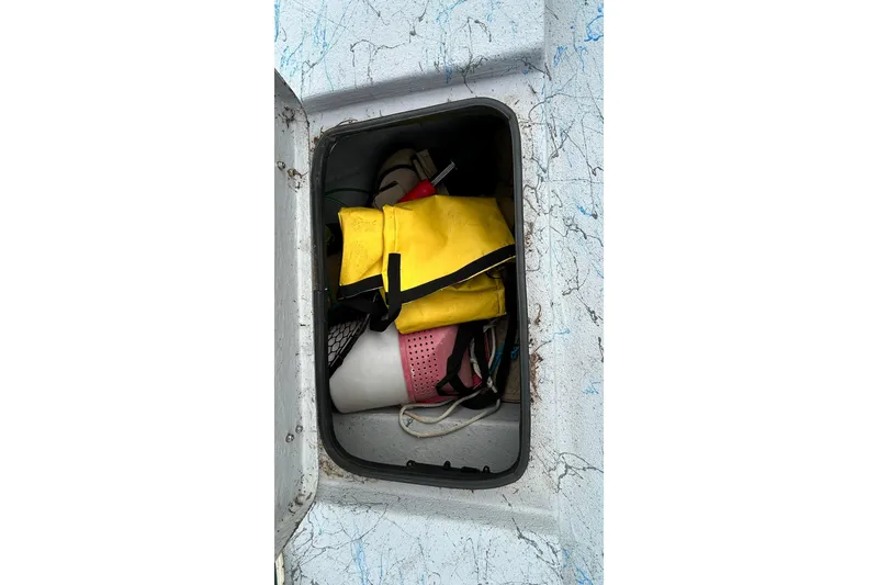 Slide: The Image of Open storage compartment on 2022 Transcat 200 SVT boat with safety gear inside. - 29