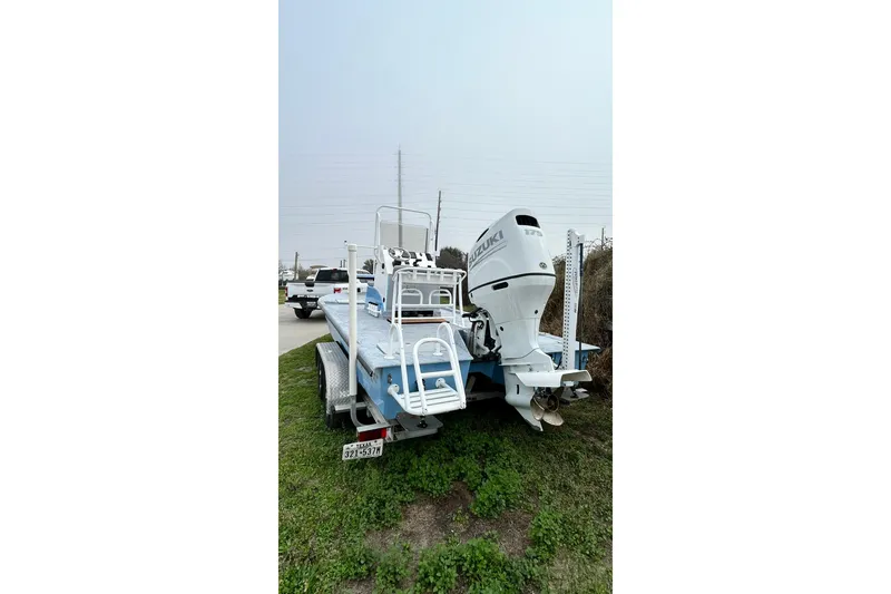 Slide: The Image of 2022 Transcat 200 SVT boat with Suzuki outboard motor on trailer. - 6