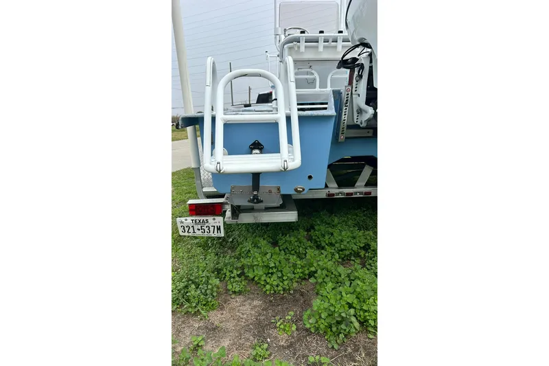 Slide: The Image of 2022 Transcat 200 SVT boat rear view with Texas license plate on grass. - 7