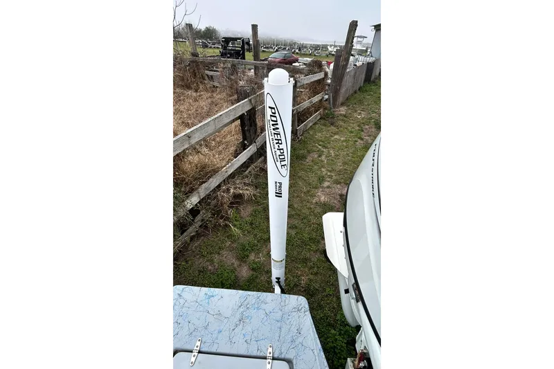 Slide: The Image of White Power-Pole Pro II anchor on a Transcat 200 SVT, 2022 model, near a wooden fence. - 9