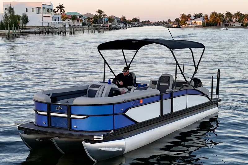 Slide: The Image of 2024 Barletta Cabrio 24UC pontoon boat on calm water at sunset. - 10