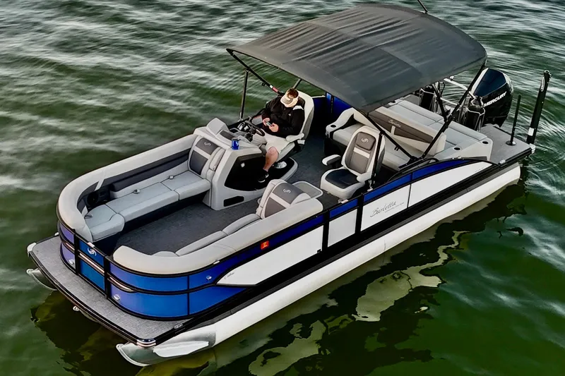 Slide: The Image of 2024 Barletta Cabrio 24UC pontoon boat on water, featuring spacious seating and canopy. - 11