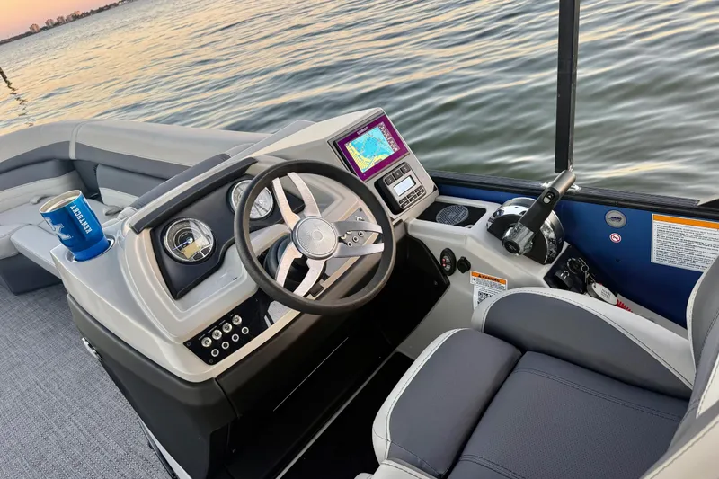 Slide: The Image of 2024 Barletta Cabrio 24UC boat interior with steering wheel and navigation system. - 20