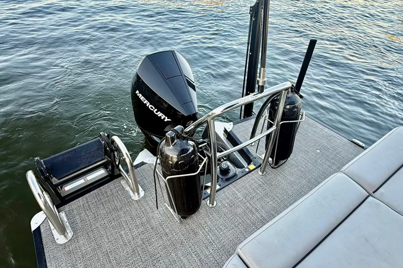 Slide: The Image of 2024 Barletta Cabrio 24UC pontoon boat with Mercury outboard motor on water. - 32