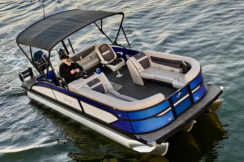 Slide: The Image of 2024 Barletta Cabrio 24UC pontoon boat cruising on water, featuring spacious seating and canopy. - 9